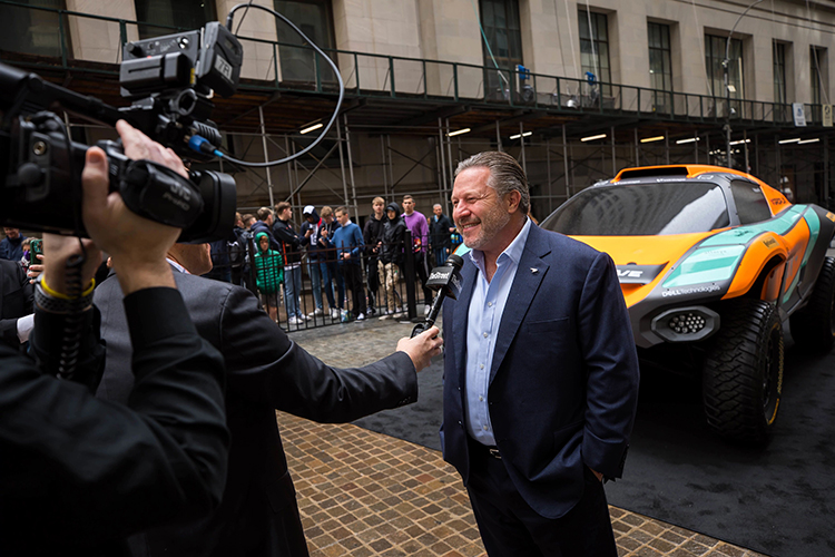 McLaren Racing’s Zak Brown interviewed at the team’s Extreme E racing SUV in front of the NYSE